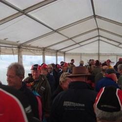 Members enjoying spit roast food