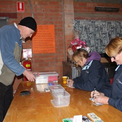 Chris Buying Raffle Tickets from Sue & Jenny