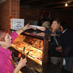 Stella & Sue Serving the Spit Roast Lamb & Pork