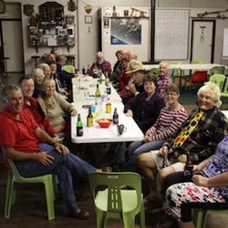 Everyone gathered around table, lots of stories and laughs.