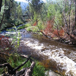 Pinch River flowing strongly under bridge on Barry way