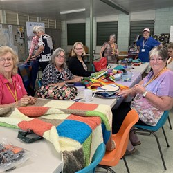 DAY 8. Sewing BOG labels on rugs for donation. 