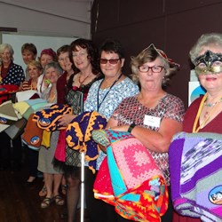 The busy knitting ladies with their rugs .