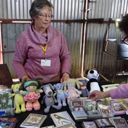 Ros with her table of lovely knitted dolls and other goodies.