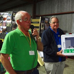 Greg presenting the defibrilator & cheque to Ray for Rotary.