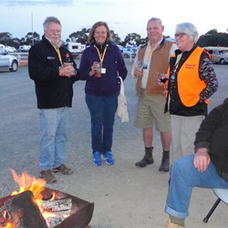 Warming up around the fire at welcome drinks evening.