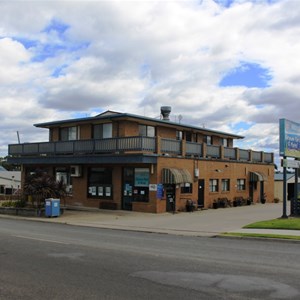 Reception is at the canopied door at the side of the building