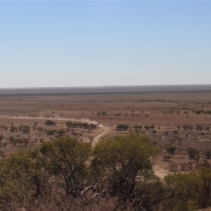 A dirt road leads in from the highway