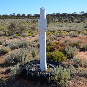 Original tyre and post at the site, with the replica plaque 