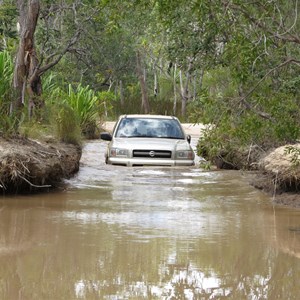 Creek crossing with deep ruts