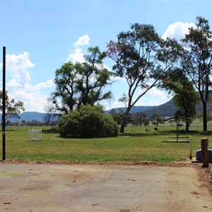 Camping is behind a disused tennis court. Note the dump point.