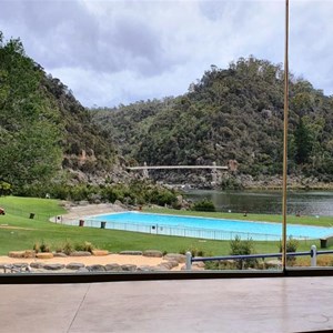 Pool and suspension bridge viewed from the caf?.