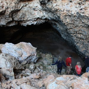 View of walkers entering cave