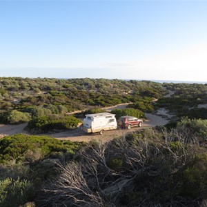 Sheltered campsite behind dunes