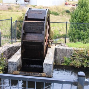 An original water wheel displayed driven by the water flow