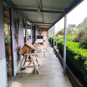 Old dairy production equipment displayed on the veranda