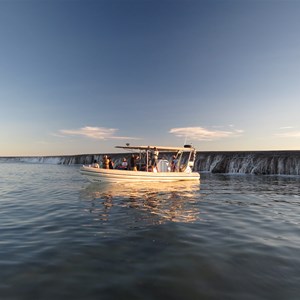 Water cascades off reef as tide drops