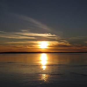 Gold and purple glassy water sunset