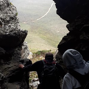 Passing through the cave hole in the rock near the top on the way back down