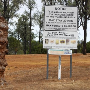 Restriction signs and a sample of a "knobbly tree" found in the area