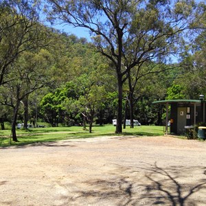 The toilet block is located on the edge of the parking area.