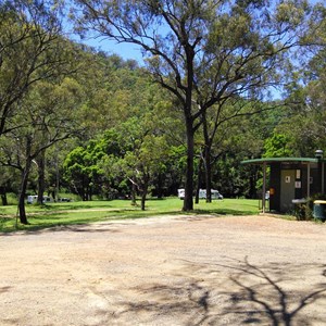 The toilet block is located on the edge of the parking area.